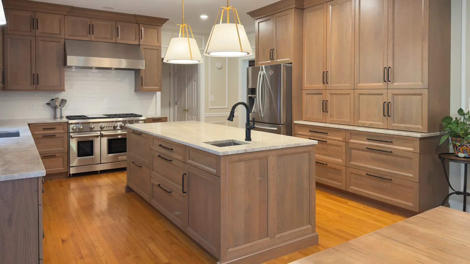Modern Woodbridge kitchen featuring custom Wellsford cherry cabinetry with a warm grey stain and Perla Venata Quartzite countertops.